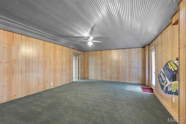 732 Woodridge Ln, Perryville, MO 63775 - carpeted empty room with a ceiling fan and wood walls