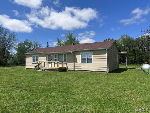 view of front of home with a front lawn and a deck