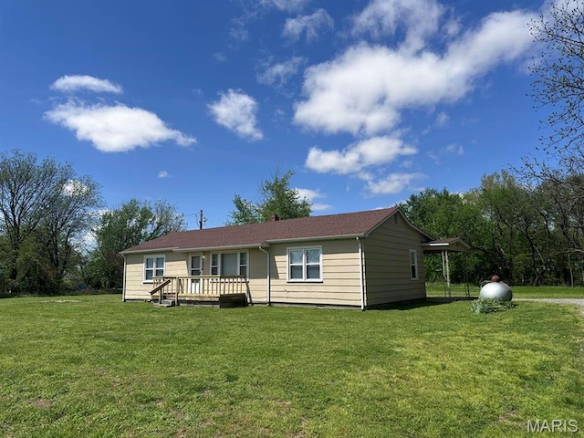 view of front of house with a front yard and a wooden deck