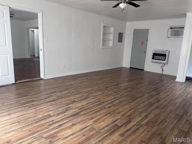 unfurnished living room featuring heating unit, a ceiling fan, a wall unit AC, dark wood-style floors, and crown molding