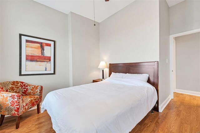 4125 Chouteau Ave, Saint Louis, MO 63110 - bedroom featuring wood finished floors, baseboards, high vaulted ceiling, and ceiling fan