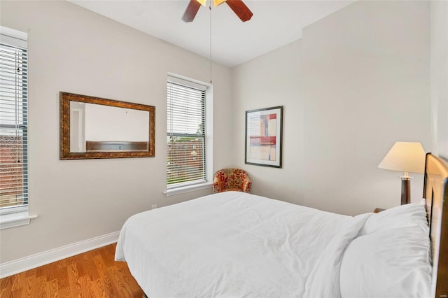 4125 Chouteau Ave, Saint Louis, MO 63110 - bedroom with wood finished floors, baseboards, and ceiling fan
