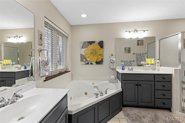 bathroom with a whirlpool tub, a shower stall, two vanities, and tile patterned floors