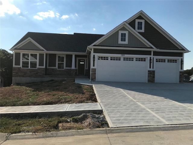 1605 Sugar Creek Dr, Festus, MO 63028 - view of front of property featuring driveway, stone siding, and an attached garage