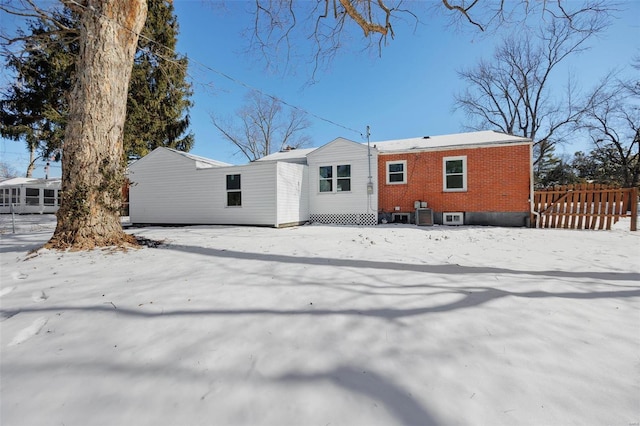 17 S Floridale Dr, Saint Louis, MO 63135 - snow covered house with brick siding, central AC unit, and fence
