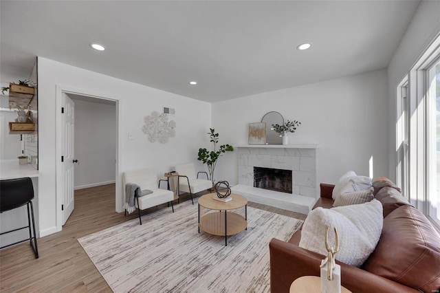 17 S Floridale Dr, Saint Louis, MO 63135 - living room featuring light wood-type flooring, a high end fireplace, recessed lighting, and baseboards