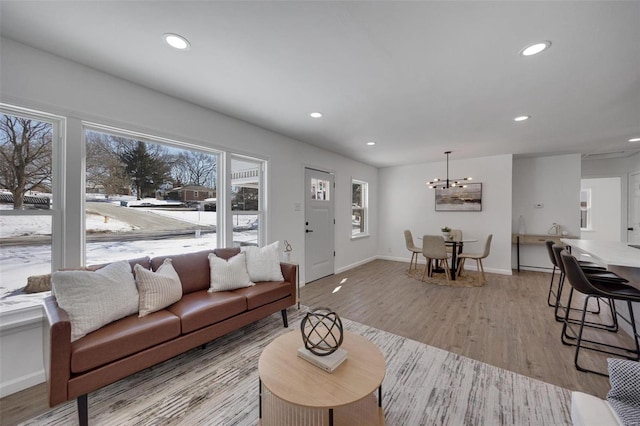 17 S Floridale Dr, Saint Louis, MO 63135 - living area with a chandelier, healthy amount of natural light, recessed lighting, and light wood-style flooring