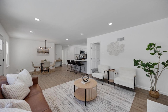 17 S Floridale Dr, Saint Louis, MO 63135 - living area featuring light wood-style flooring, recessed lighting, and baseboards