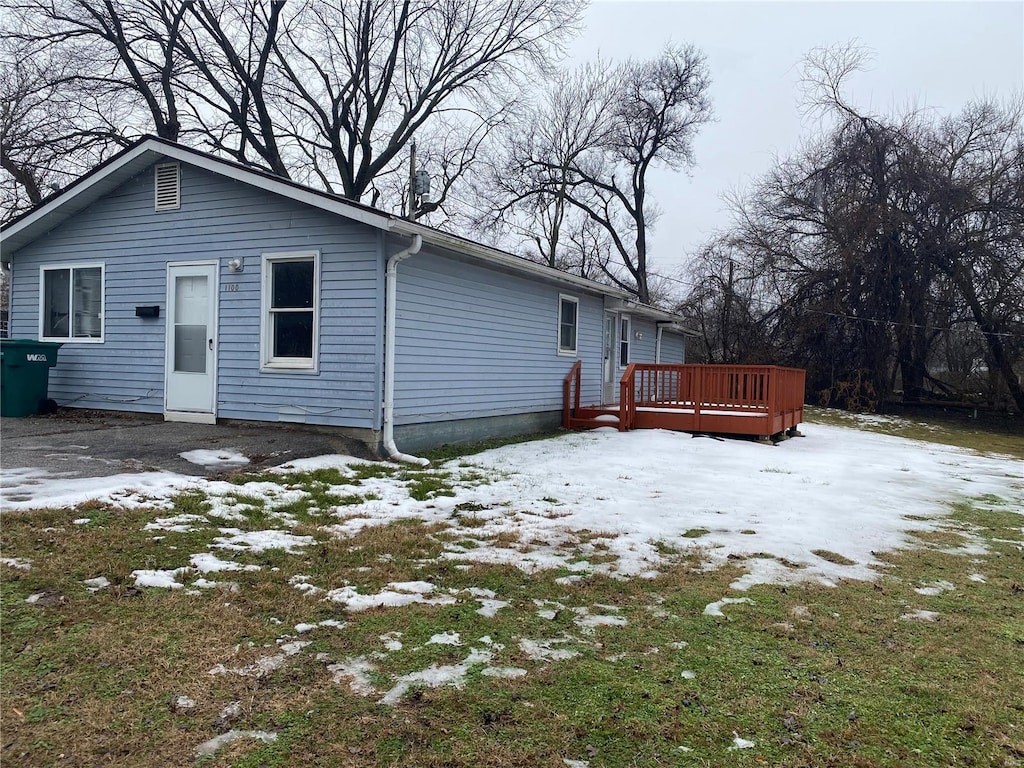 snow covered property featuring a wooden deck