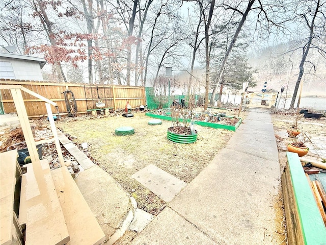 10063 Mockingbird Dr, Holiday Shores, MO 63624 - fenced backyard featuring a vegetable garden