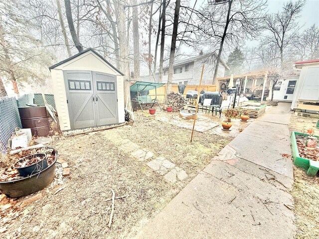 10063 Mockingbird Dr, Holiday Shores, MO 63624 - fenced backyard featuring a storage unit and an outdoor structure