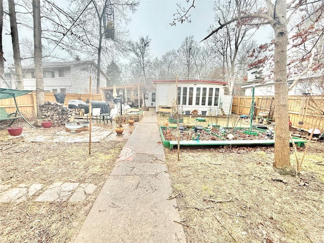 10063 Mockingbird Dr, Holiday Shores, MO 63624 - rear view of property with a vegetable garden and a fenced backyard