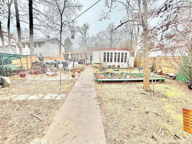 10063 Mockingbird Dr, Holiday Shores, MO 63624 - back of house with a vegetable garden and a fenced backyard