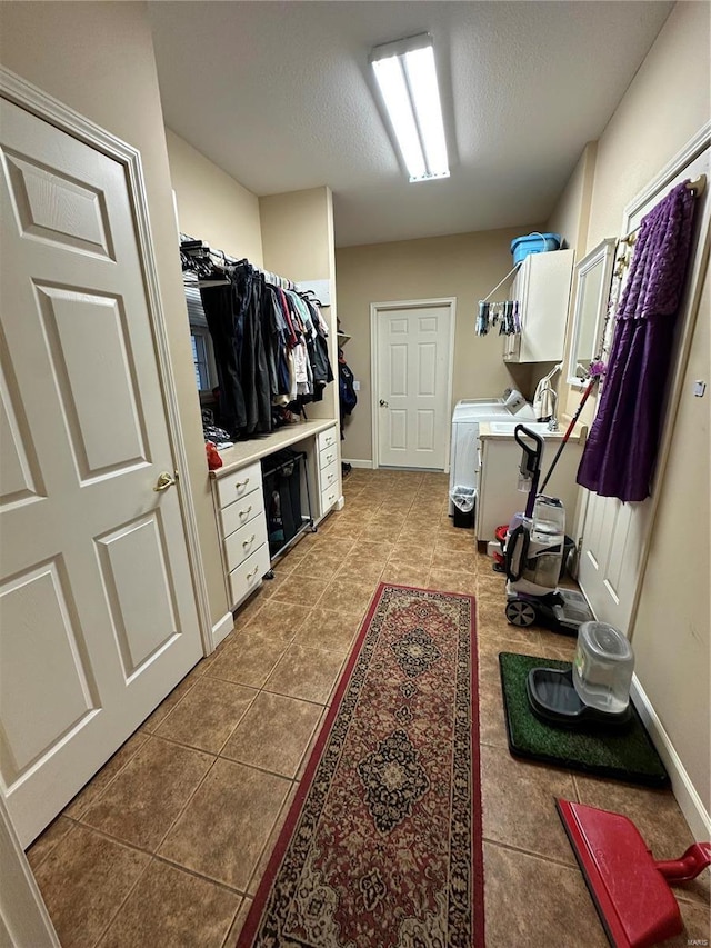 10 Cherokee Rdg, Sikeston, MO 63801 - laundry area featuring tile patterned floors, a textured ceiling, baseboards, and washing machine and dryer