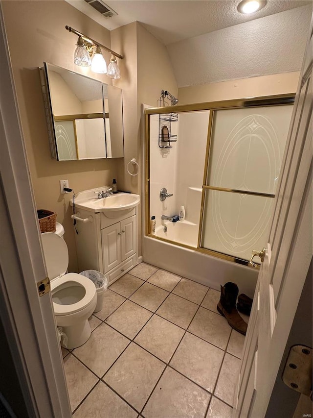 10 Cherokee Rdg, Sikeston, MO 63801 - bathroom featuring vanity, tile patterned flooring, a textured ceiling, toilet, and bath / shower combo with glass door
