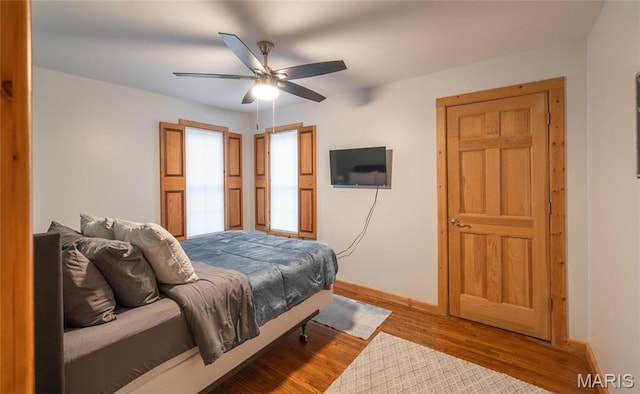 801 E 14th St, Rolla, MO 65401 - bedroom with baseboards, wood finished floors, and a ceiling fan