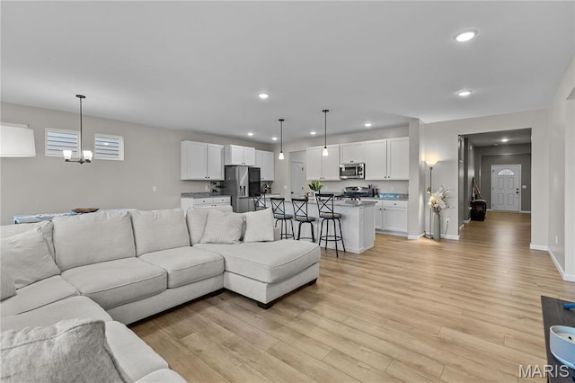 138 Rhythm Point Dr, Saint Peters, MO 63376 - living area with light wood-style flooring, recessed lighting, baseboards, and a chandelier