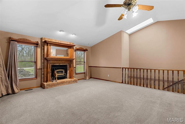 23 Falling Leaf Dr, Lake St Louis, MO 63367 - unfurnished living room featuring vaulted ceiling, a ceiling fan, carpet flooring, baseboards, and a skylight