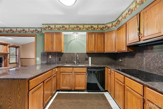 23 Falling Leaf Dr, Lake St Louis, MO 63367 - kitchen featuring black appliances, a sink, a peninsula, brown cabinetry, and decorative backsplash