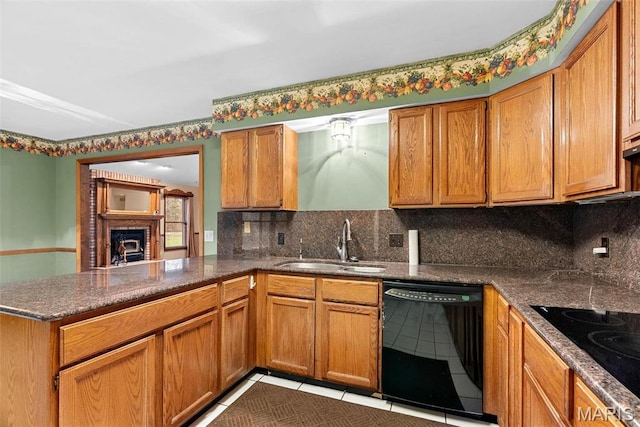 23 Falling Leaf Dr, Lake St Louis, MO 63367 - kitchen with black appliances, a sink, a peninsula, tasteful backsplash, and brown cabinetry