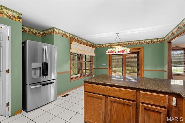 23 Falling Leaf Dr, Lake St Louis, MO 63367 - kitchen featuring stainless steel refrigerator with ice dispenser, light tile patterned floors, decorative light fixtures, and brown cabinets