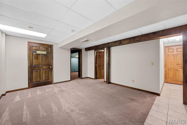 23 Falling Leaf Dr, Lake St Louis, MO 63367 - finished below grade area featuring a drop ceiling, baseboards, light colored carpet, and light tile patterned floors