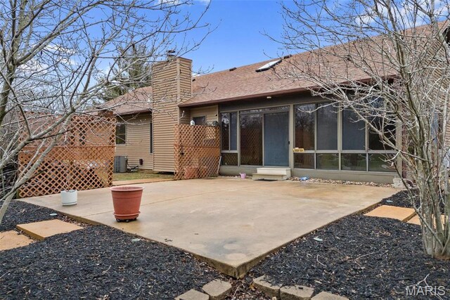 23 Falling Leaf Dr, Lake St Louis, MO 63367 - rear view of house with central air condition unit, a sunroom, a chimney, and a patio