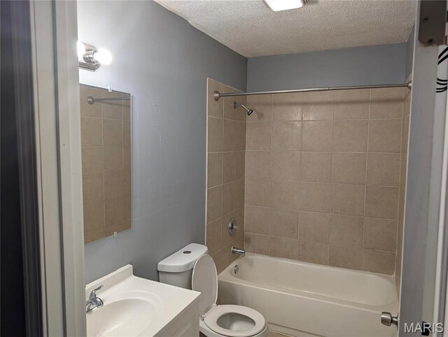 10544 Decker Ave, Saint Louis, MO 63114 - full bathroom featuring a textured ceiling, toilet, washtub / shower combination, and vanity