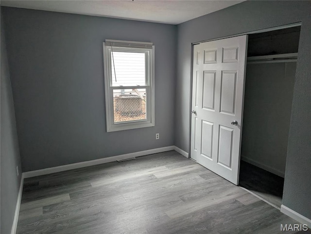 10544 Decker Ave, Saint Louis, MO 63114 - unfurnished bedroom with wood finished floors, a closet, and baseboards