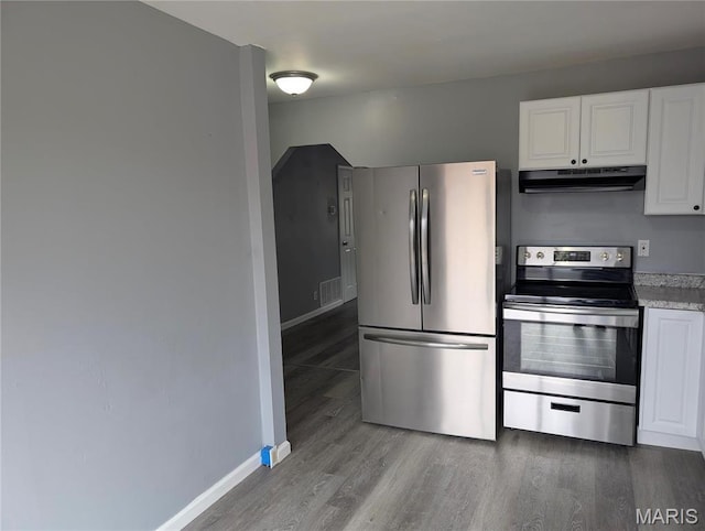 10544 Decker Ave, Saint Louis, MO 63114 - kitchen featuring appliances with stainless steel finishes, under cabinet range hood, wood finished floors, white cabinetry, and baseboards