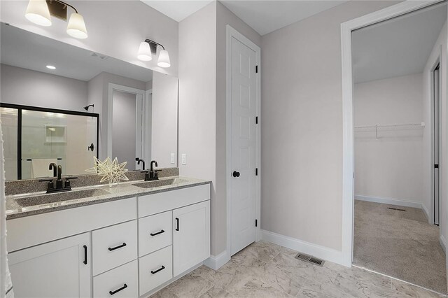 1035 Morgan Meadow Dr, Wentzville, MO 63385 - full bathroom featuring a shower stall, baseboards, double vanity, a walk in closet, and marble look tiles