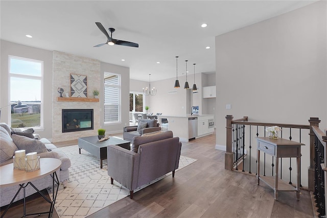 1035 Morgan Meadow Dr, Wentzville, MO 63385 - living area featuring ceiling fan, light wood-style flooring, a large fireplace, recessed lighting, and a chandelier