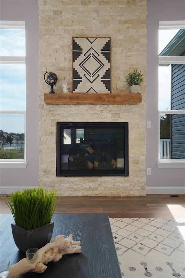 1035 Morgan Meadow Dr, Wentzville, MO 63385 - detailed view of baseboards, a fireplace, and wood finished floors