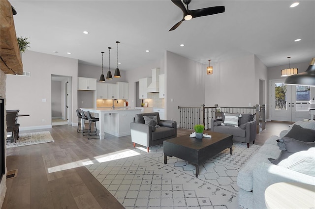 1035 Morgan Meadow Dr, Wentzville, MO 63385 - living room featuring ceiling fan, light wood-style floors, recessed lighting, and baseboards