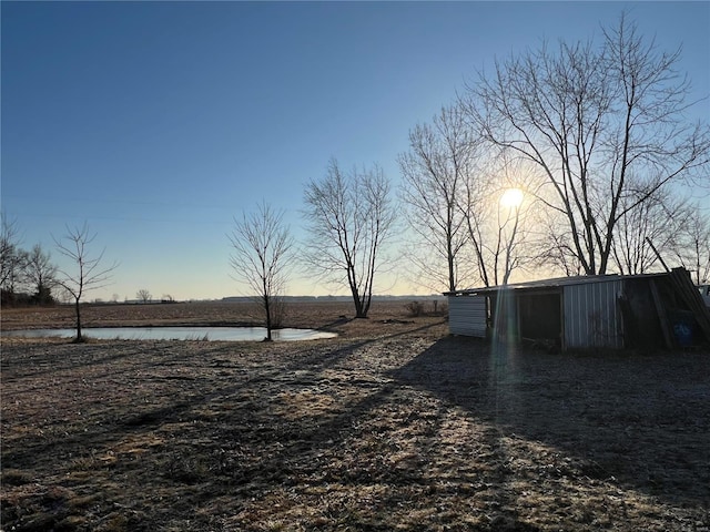 1539 Bcr 628, Puxico, MO 63960 - yard at dusk with an outdoor structure, a water view, and an outbuilding