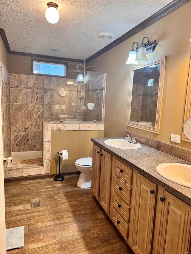1539 Bcr 628, Puxico, MO 63960 - full bathroom featuring a textured ceiling, wood finished floors, walk in shower, toilet, and double vanity