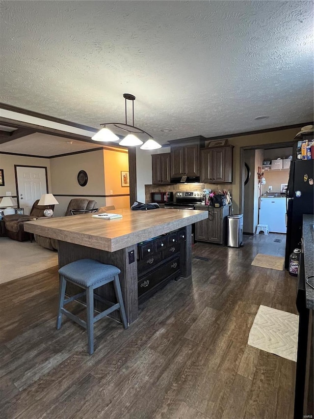 1539 Bcr 628, Puxico, MO 63960 - kitchen with wood counters, freestanding refrigerator, dark wood-type flooring, a textured ceiling, and a breakfast bar
