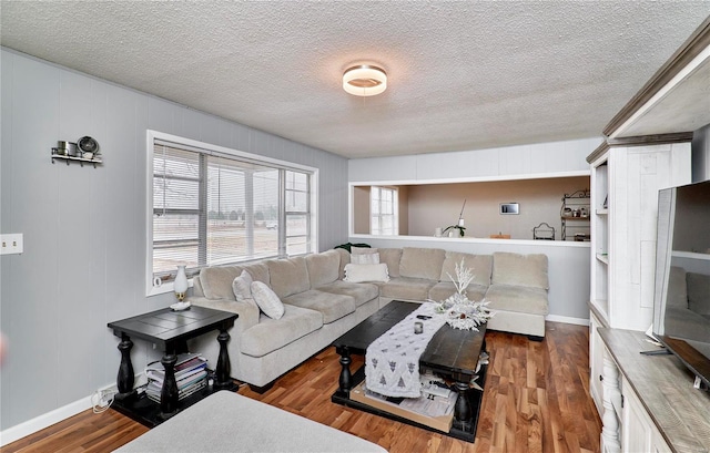 1991 State Highway H, Sikeston, MO 63780 - living room with a textured ceiling, wood finished floors, and baseboards