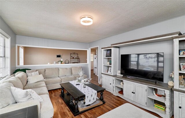 1991 State Highway H, Sikeston, MO 63780 - living area featuring a textured ceiling and dark wood finished floors