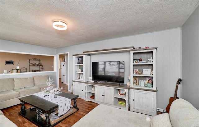 1991 State Highway H, Sikeston, MO 63780 - living area with a textured ceiling and wood finished floors