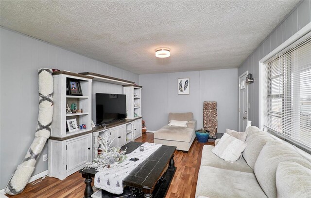 1991 State Highway H, Sikeston, MO 63780 - living area with dark wood-style flooring and a textured ceiling
