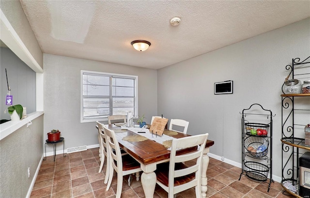 1991 State Highway H, Sikeston, MO 63780 - dining space featuring a textured ceiling and baseboards