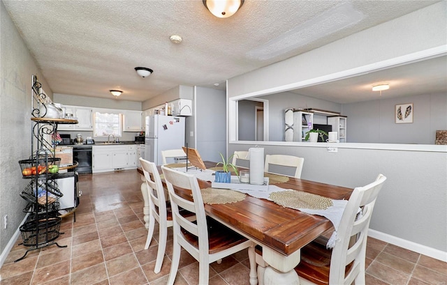 1991 State Highway H, Sikeston, MO 63780 - dining space featuring a textured ceiling and baseboards