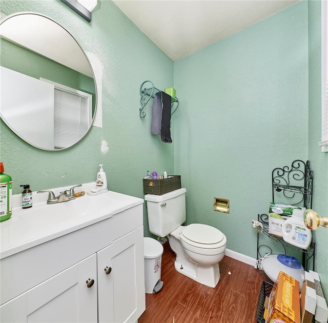1991 State Highway H, Sikeston, MO 63780 - half bath featuring toilet, wood finished floors, vanity, a textured wall, and baseboards