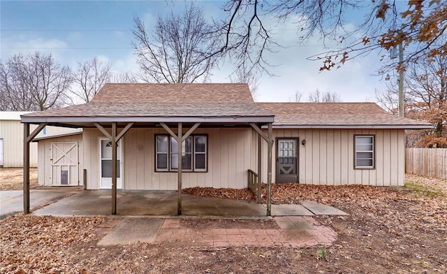 1991 State Highway H, Sikeston, MO 63780 - view of front of house with fence, roof with shingles, and a patio area