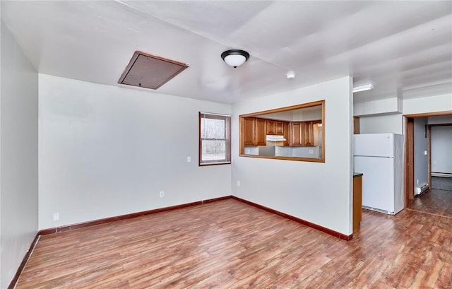 1991 State Highway H, Sikeston, MO 63780 - spare room with wood finished floors, baseboards, and attic access