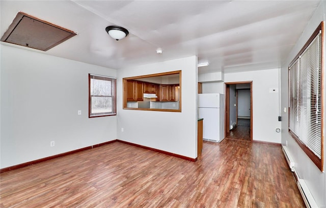 1991 State Highway H, Sikeston, MO 63780 - unfurnished living room with wood finished floors, baseboards, and baseboard heating