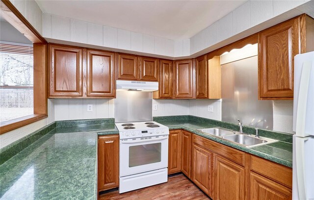 1991 State Highway H, Sikeston, MO 63780 - kitchen with white appliances, under cabinet range hood, a sink, and brown cabinets