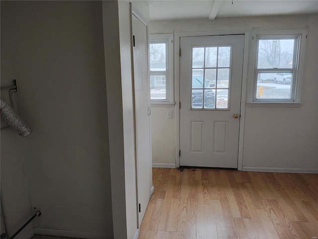 entryway with light wood-style flooring and baseboards