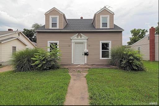 cape cod home with a front lawn and a shingled roof